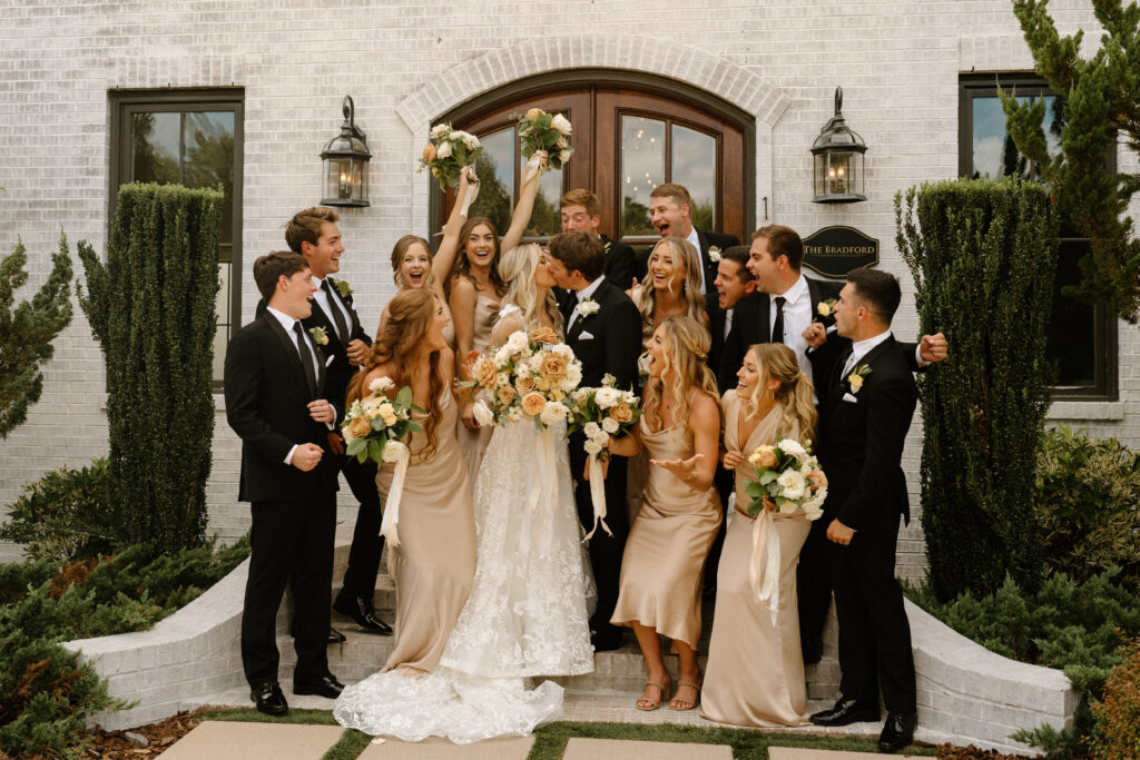 bridal party cheers for bride and groom