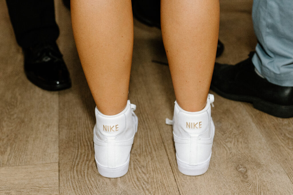 bride wears custom nike shoes at reception